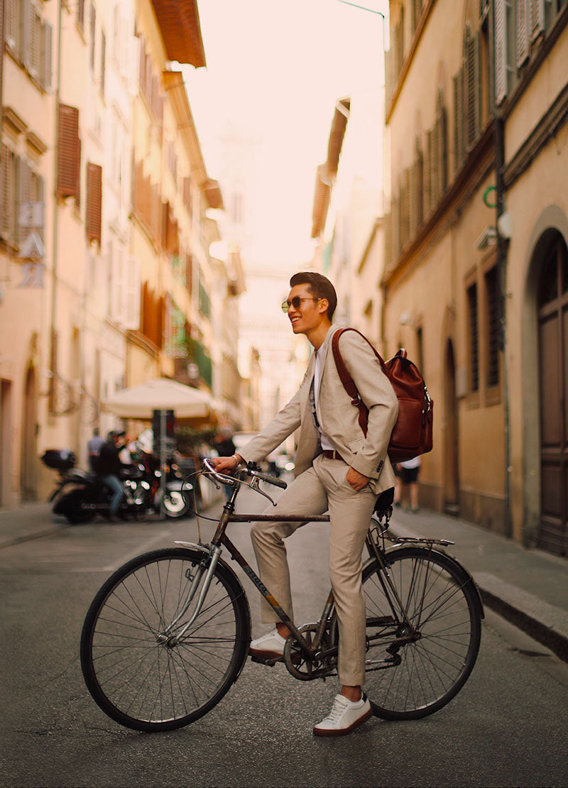 Qmike rides bike with Serapian Backpack