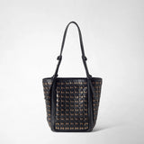 Front view: BUCKET IN MOSAICO MESTIERI D'ARTE shows a tall, softly shaped bucket bag with a black woven leather pattern, light accents, and long knotted shoulder straps.