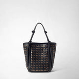 Front view: BUCKET IN MOSAICO MESTIERI D'ARTE appears as a black bucket bag with a woven mosaic pattern, gold-tone accents, and slim handles with knot details against a light background.