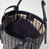 Detail view: BUCKET IN MOSAICO MESTIERI D'ARTE is open, showing its woven leather lining, black straps, and an interior label reading “SERAPIAN MILANO MADE IN ITALY”.