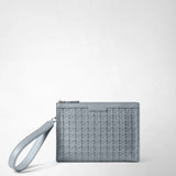 Front view: CLUTCH IN MOSAICO features Arctic blue woven Mosaico leather, a zipper and a wrist strap against a light background; the lettering “SERAPIAN MILANO” is visible.