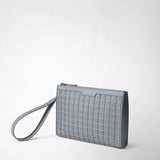 Front view: CLUTCH IN MOSAICO in arctic blue geometric woven leather, with a zipper and wrist strap, lies against a light background; “SERAPIAN MILANO” is printed on the bag.