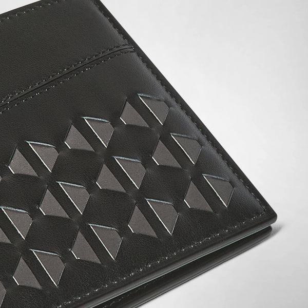 Detail view: 6-CARD BILLFOLD WALLET IN MOSAICO displays a close-up of black nappa leather with a hand-woven geometric Mosaico pattern, highlighting the intricate craftsmanship.