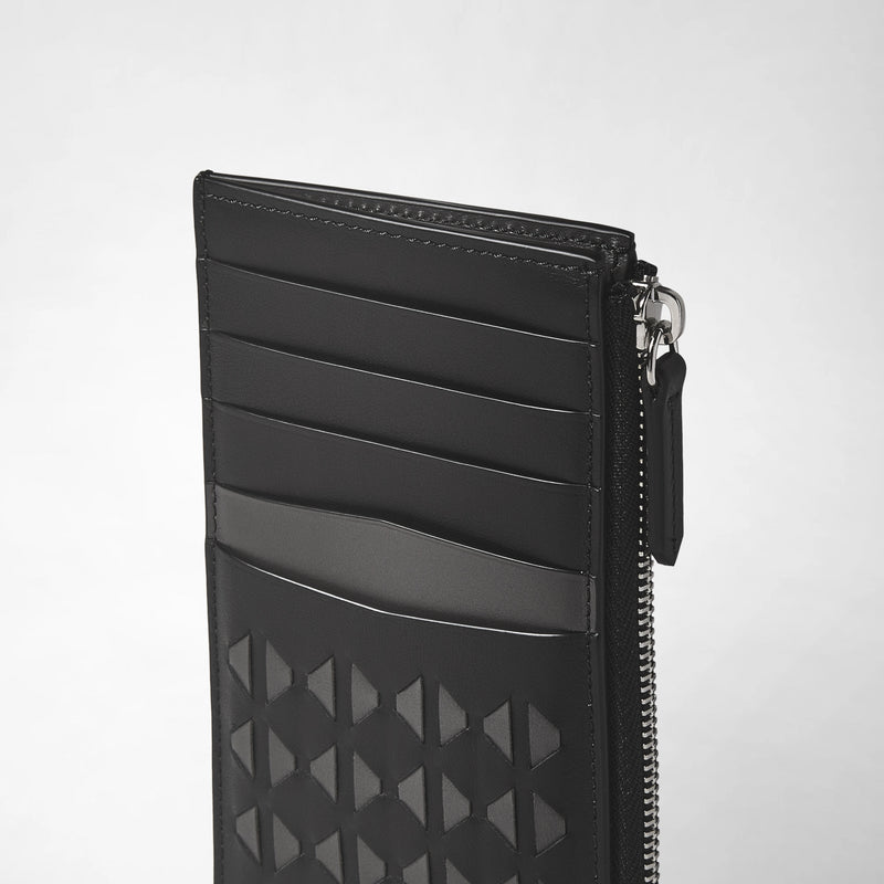 Side view: ZIP CARD CASE IN MOSAICO shows a slim black leather card case with five card slots, a textured geometric Mosaico pattern, and a silver zipper.