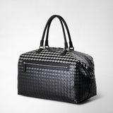Front view: TRAVEL BAG IN MOSAICO with black handles, geometric pattern, and front zipper; made of Chiaroscuro Mosaico nappa leather.