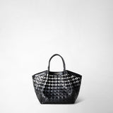 Frontal view: MINI SECRET BAG IN MOSAICO shows a small, black woven leather bag with two handles, featuring a geometric pattern and the text 'SERAPIAN MILANO' on the front.