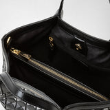 Detail view: MINI SECRET BAG IN MOSAICO shows the interior of a petite black woven leather bag with gold zipper and clasp, highlighting luxurious lining and organization.