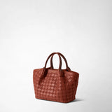Front view: MINI SECRET BAG IN MOSAICO appears as a brick-red handbag with a textured Mosaico leather surface and two handles against a light background; gold “SERAPIAN MILANO” embossing.