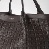 Detail view: SMALL SECRET TOTE BAG IN RIBBON MOSAICO shows dark brown, intricately woven leather and handles; “SERAPIAN MILANO” appears along the top edge.