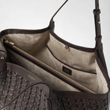 Detail view of the SECRET TOTE BAG IN RIBBON MOSAICO: the open interior compartment shows a zipper, pockets, and dark leather trim; the woven Mosaico leather is visible on the outside. The label reads “SERAPIAN MILANO MADE IN ITALY”.