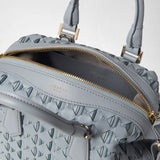 Detail view: MINI ANI BAG IN RIBBON MOSAICO with an open zipper, woven ice-blue leather, and gold-tone hardware. Visible embossing: “SERAPIAN MILANO,” “MADE IN ITALY”.