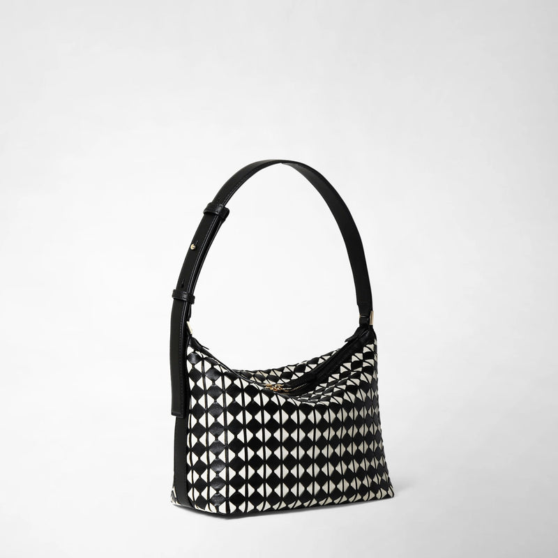 Side view: SMALL ANI SHOULDER BAG IN MOSAICO features a compact shoulder bag with a black and off-white geometric mosaic leather pattern and an adjustable black strap.