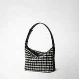Side view: SMALL ANI SHOULDER BAG IN MOSAICO features a compact shoulder bag with a black adjustable strap and a black and off-white geometric Mosaico leather pattern.