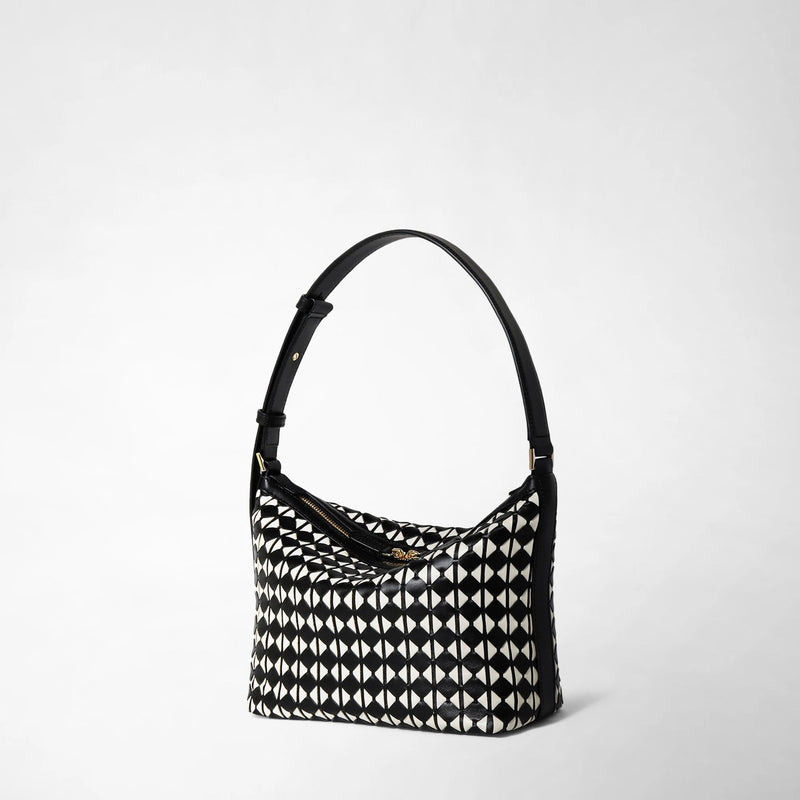 Side view: SMALL ANI SHOULDER BAG IN MOSAICO features a compact shoulder bag with a black adjustable strap and a black and off-white geometric Mosaico leather pattern.