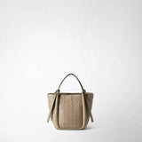Front view: MINI BUCKET IN MOSAICO stands upright against a light background; the taupe-colored bag features a woven geometric pattern and two slender handles.