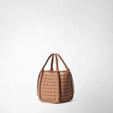 Detail view of the MINI BUCKET IN MOSAICO: the sandal-colored leather bag is shown against a light background, highlighting its embossed mosaic pattern and slender handles with small knots.