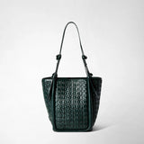 Front view: BUCKET IN RIBBON MOSAICO stands upright, showing forest-green, three-dimensional woven leather and long shoulder straps against a light, neutral background.