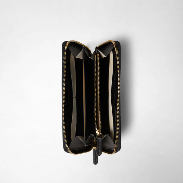 Front view of the ZIP-AROUND WALLET IN MOSAICO, opened, showing eight card slots, one note compartment, and one coin compartment with zipper. Black and off-white leather, gold-tone zipper.