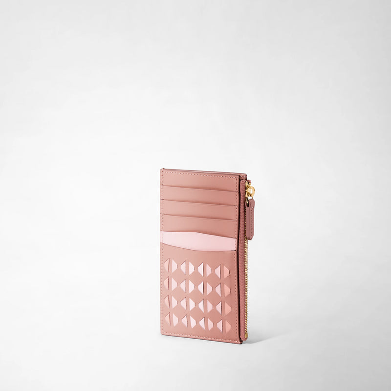 Frontal view: ZIP CARD CASE IN MOSAICO features a slim blush pink leather card case with multiple card slots, geometric Mosaico pattern, and a gold zipper on the side.