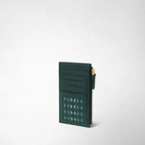 Front view: ZIP CARD CASE IN MOSAICO stands upright, showing dark green leather, card slots, a geometric Mosaico pattern, and a gold-tone side zipper against a light background.
