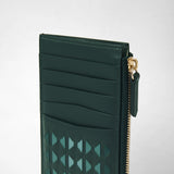 Detail view: ZIP CARD CASE IN MOSAICO shows card slots and a geometric mosaic pattern in dark green leather; a gold-tone zipper runs along the side.