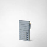 Front view: ZIP CARD CASE IN MOSAICO stands upright against a light background; the slim Arctic Blue leather case features card slots, a geometric Mosaico pattern, and a gold-colored side zipper.