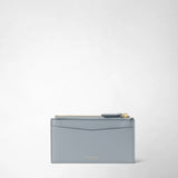 Rear view: ZIP CARD CASE IN MOSAICO shows a slim, ice-blue leather case with a gold-colored zipper and card slot; “SERAPIAN MILANO” appears at the bottom.
