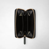Close-up: The open MINI ZIP WALLET IN MOSAICO shows black interior compartments and a gold-tone wraparound zipper against a light background.