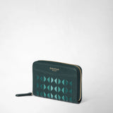 Detail view: MINI ZIP WALLET IN MOSAICO is positioned at a slight angle, showing dark green leather with a turquoise Mosaico pattern and a gold zipper; embossed with “SERAPIAN MILANO”.