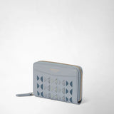 Detail view: MINI ZIP WALLET IN MOSAICO against a light background; the Arctic Blue wallet features a geometric Mosaico pattern and a gold-tone wraparound zipper. Printed lettering: “SERAPIAN MILANO”.