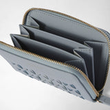 Detail view: MINI ZIP WALLET IN MOSAICO is open, showing multiple interior compartments, light blue woven leather, and gold-tone zipper teeth.