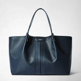 Front view: SECRET TOTE BAG IN STEPAN is a spacious, dark blue tote bag with an embossed pattern, leather trim, and long handles; “SERAPIAN MILANO” is displayed on the center panel.