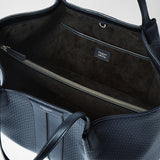 Detail view: SECRET TOTE BAG IN STEPAN is open, showing the dark-lined interior with a zip pocket and slip pocket; label: “SERAPIAN MILANO MADE IN ITALY”.