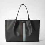 Front view: SECRET TOTE BAG IN STEPAN stands against a light background; an asphalt-gray bag with an embossed pattern, long handles, and ebony and ice-blue stripes. Visible lettering: “SERAPIAN MILANO”.