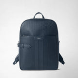 Front view: BACKPACK IN STEPAN stands against a light background; the ocean blue backpack features an embossed pattern, leather details, and a side strap. “SERAPIAN MILANO” appears on the front.
