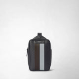 Front view: SLING BACKPACK IN STEPAN stands against a light background; asphalt-gray, S-embossed canvas with dark brown and ice-blue leather strips and the inscription “SERAPIAN MILANO”.