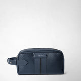 Front view: WASHBAG IN STEPAN stands closed on a light-colored surface; the ocean-blue washbag features an embossed pattern, leather details, a zipper, and the inscription “SERAPIAN MILANO”.