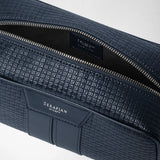 Detail view: WASHBAG IN STEPAN, open with a silver zipper, dark inner compartment, and embossed ocean-blue surface; “SERAPIAN MILANO” appears on the leather patch.