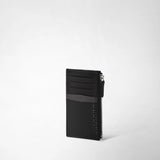 Frontal view: ZIP CARD CASE IN STEPAN displays a slim black card case with a textured Stepan canvas lower section, leather upper section, card slots, and a side zipper.
