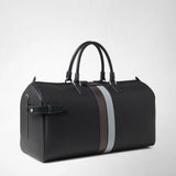 Front view: HOLDALL IN STEPAN in dark grey embossed canvas with a brown and light blue central stripe, two handles and a side leather strap; “SERAPIAN” appears on the plaque.