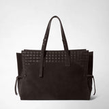 Front view of the MAXI MARO BAG IN SUEDE AND MOSAICO: the spacious dark brown tote stands against a light background, showing long handles, a woven pattern, and side ties.
