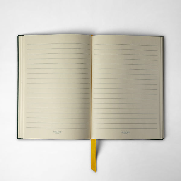 Front view of an open NOTEBOOK IN CACHEMIRE LEATHER with lined cream pages, yellow bookmark, and Serapian logo at the bottom of each page.