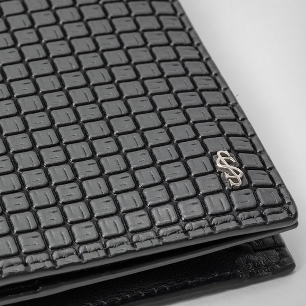 Front view of the BUSINESS CARD CASE IN STEPAN, featuring textured, S-etched surface in Asphalt Gray and Eclipse Black with a silver Serapian logo.